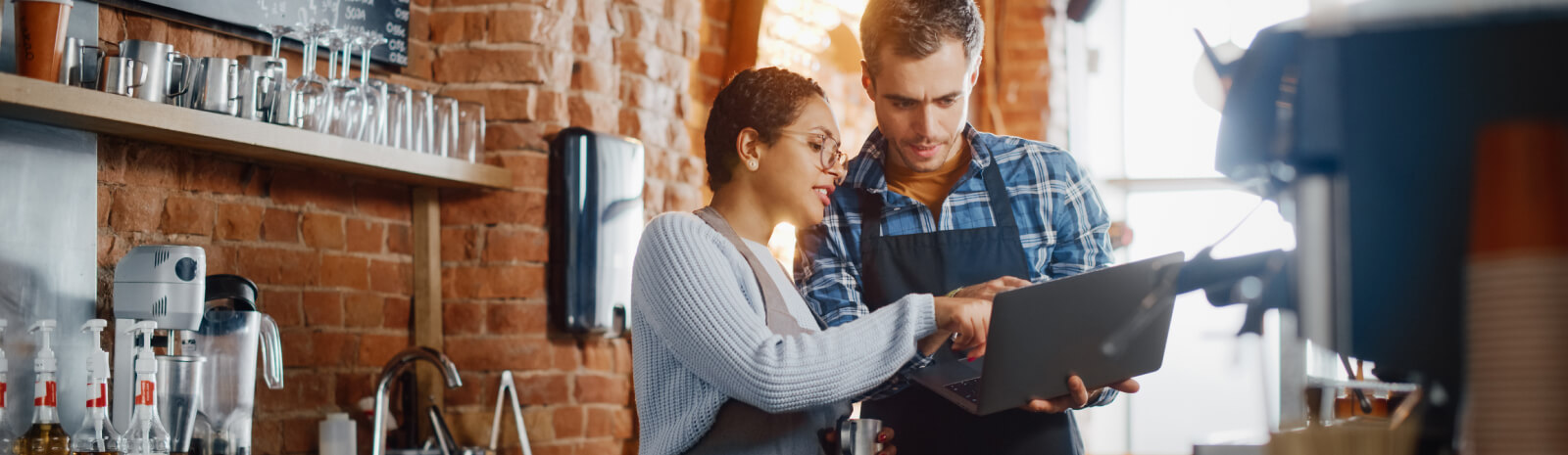 Cafe workers looking at a laptop